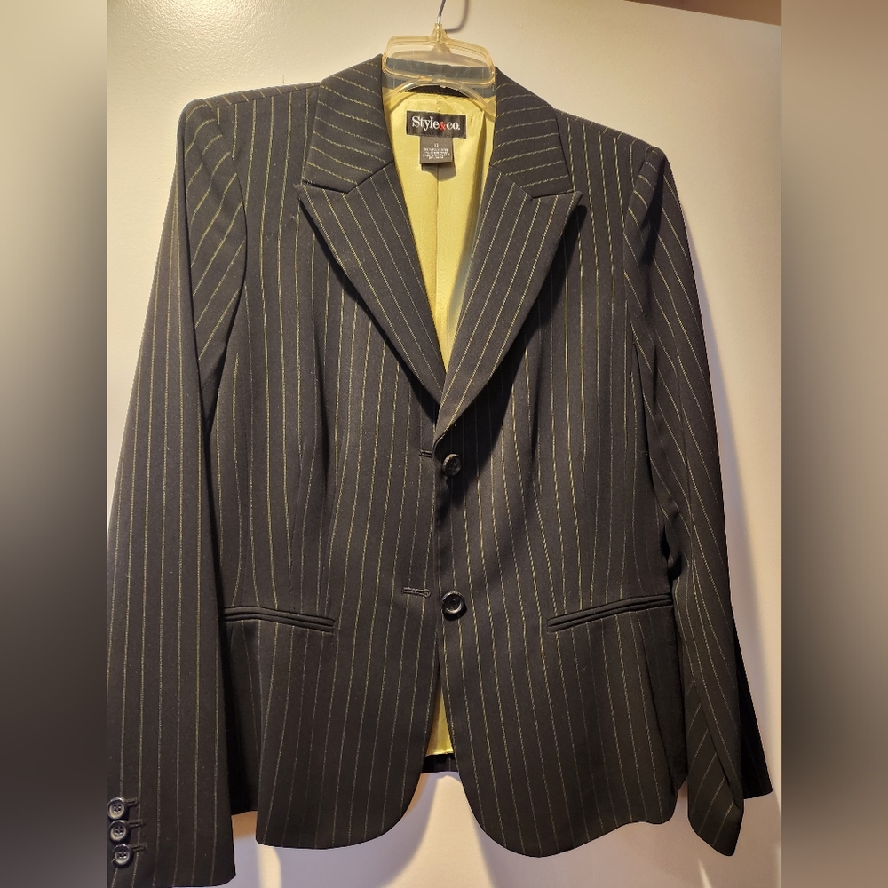 Suit jacket only. Black with thin white pinstripes, green lining.  Size 12
